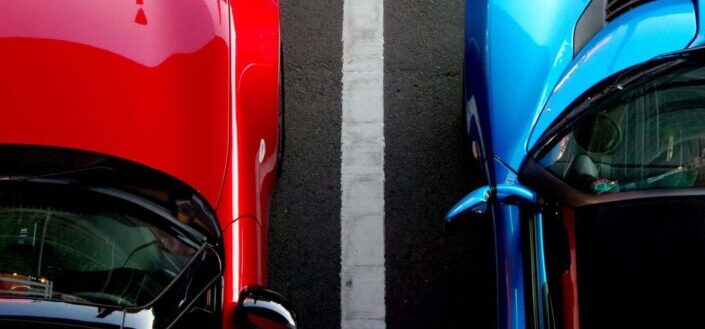 Red and Blue Cars Parked on Asphalt Road