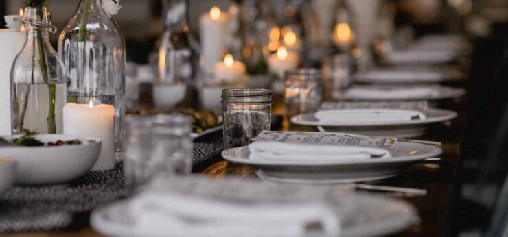white ceramic plates and candlelit table